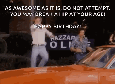 Two Men Are Dancing In Front Of An Orange Car With The Words `` As Awesome As It Is , Do Not Attempt . GIF
