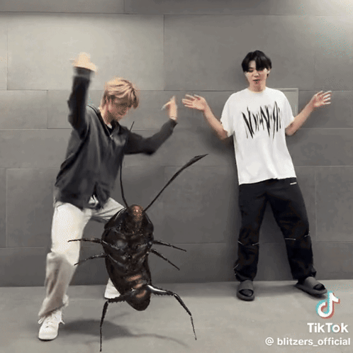 Two Men Are Dancing Next To A Cockroach That Has Tiktok Written At The Bottom GIF