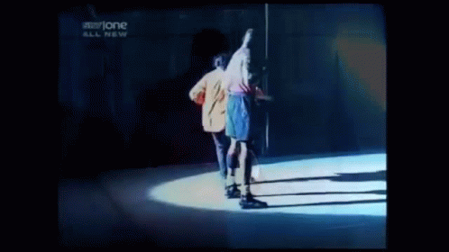 Two Men Are Dancing On A Stage In Front Of A Sign That Says Storyone GIF