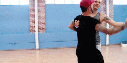 Two Men Are Dancing Together In A Dance Studio GIF