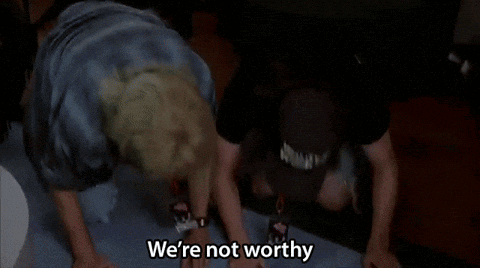 Two Men Are Dancing With Their Hands In The Air And One Of Them Is Saying We 'Re Not Worthy . GIF