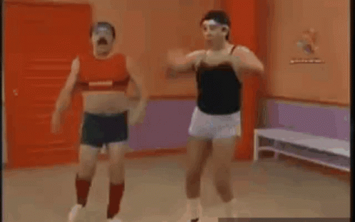 Two Men Are Doing Exercises In A Gym . GIF