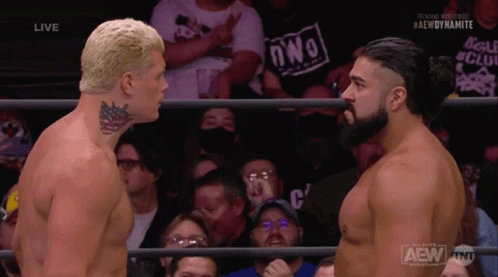 Two Men Are Facing Each Other In A Wrestling Ring With A Crowd Behind Them And The Words Aew Dynamite On The Bottom GIF