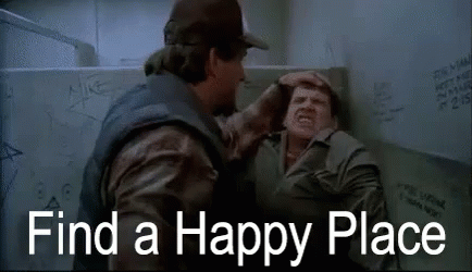 Two Men Are Fighting In A Bathroom With The Words `` Find A Happy Place '' Written On The Screen . GIF