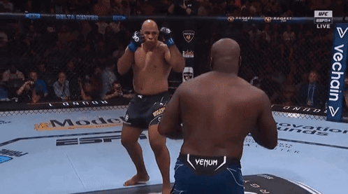Two Men Are Fighting In A Boxing Ring And One Of Them Has Venum On His Shorts GIF
