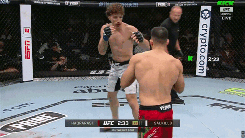 Two Men Are Fighting In A Boxing Ring With A Banner For Crypto.com GIF