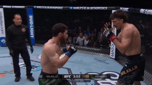 Two Men Are Fighting In A Boxing Ring With A Bud Light Advertisement Behind Them GIF