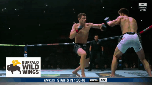 Two Men Are Fighting In A Boxing Ring With A Buffalo Wild Wings Logo On The Screen GIF