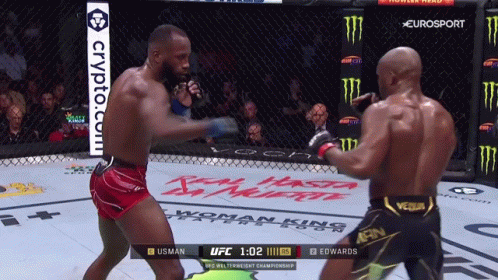 Two Men Are Fighting In A Boxing Ring With A Crypto.com Advertisement In The Background GIF