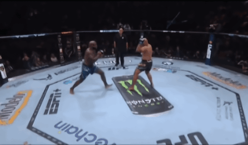 Two Men Are Fighting In A Boxing Ring With A Monster Energy Drink Advertisement On The Floor GIF