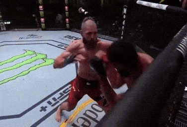 Two Men Are Fighting In A Boxing Ring With A Monster Energy Logo In The Background GIF