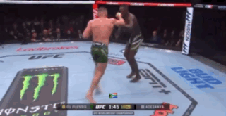 Two Men Are Fighting In A Boxing Ring With A Monster Energy Logo On The Floor GIF