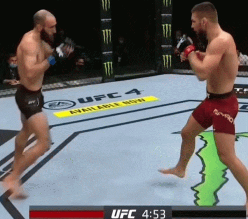 Two Men Are Fighting In A Boxing Ring With A Monster Energy Sign In The Background GIF