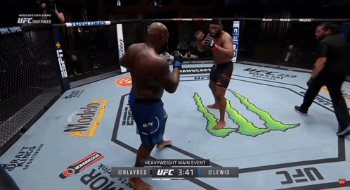 Two Men Are Fighting In A Boxing Ring With A Monster Logo On The Floor GIF