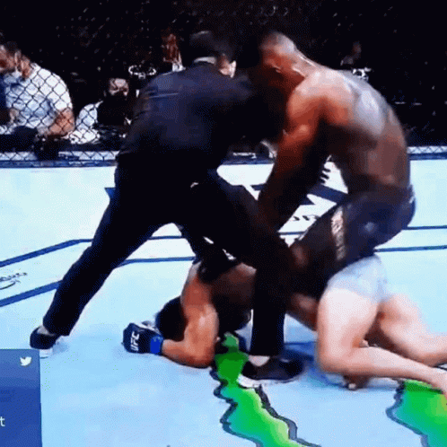 Two Men Are Fighting In A Boxing Ring With A Referee Watching . GIF