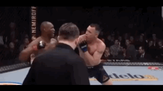 Two Men Are Fighting In A Boxing Ring With A Referee Watching GIF