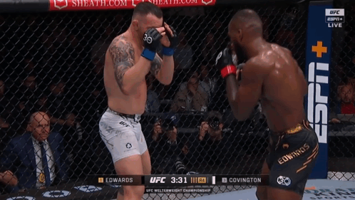 Two Men Are Fighting In A Boxing Ring With A Sign That Says Espn + GIF