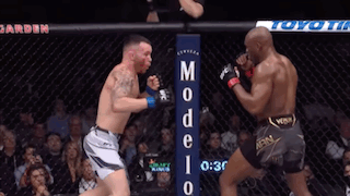 Two Men Are Fighting In A Boxing Ring With A Sign That Says Modelo GIF