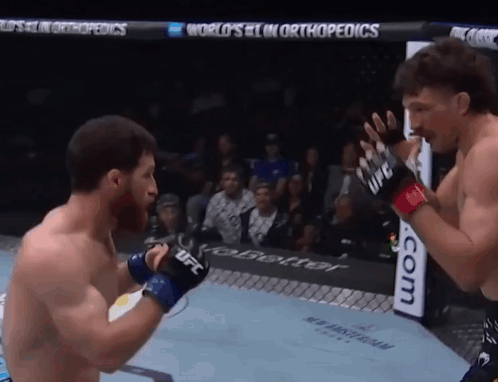 Two Men Are Fighting In A Boxing Ring With A Sign That Says World 'S # 1 In Orthopedics Behind Them GIF