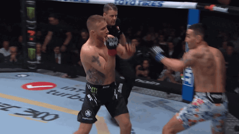 Two Men Are Fighting In A Boxing Ring With Toyo Tires On The Side GIF
