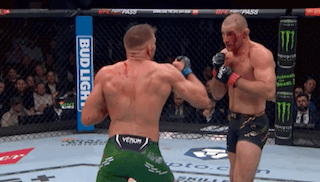 Two Men Are Fighting In A Cage With A Bud Light Sign In The Background . GIF