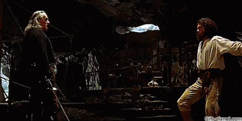 Two Men Are Fighting In A Dark Room With Gifsplanet.com At The Bottom Of The Image GIF