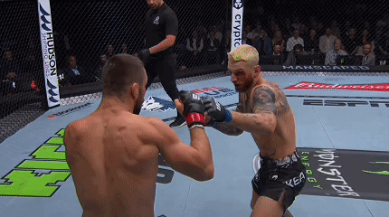 Two Men Are Fighting In A Ring With A Monster Energy Banner On The Floor GIF