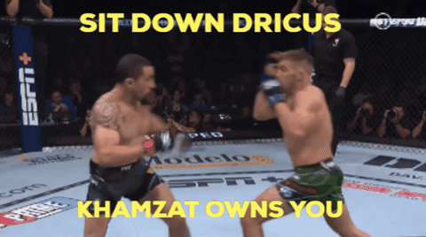 Two Men Are Fighting In A Ring With The Words Sit Down Drius Khamzat Owns You Above Them GIF