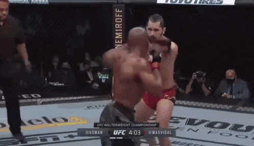 Two Men Are Fighting In A Ufc Welterweight Championship Match Between Husman And Masvidal GIF