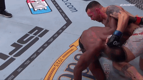 Two Men Are Fighting On A Boxing Ring With A Sign That Says Prime GIF