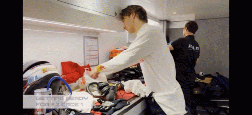 Two Men Are Getting Ready For A Race And One Has The Word Flip On His Back GIF