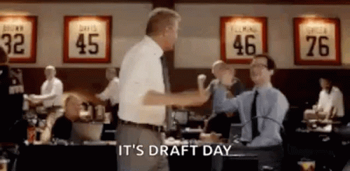 Two Men Are Giving Each Other A High Five In A Room . GIF