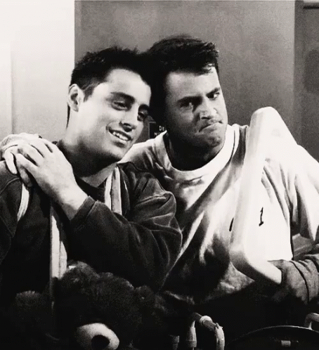 Two Men Are Hugging Each Other And One Has The Number 1 On His Shirt GIF