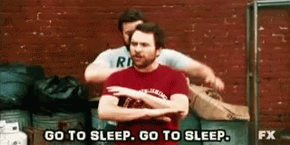 Two Men Are Hugging Each Other In Front Of A Brick Wall And One Of Them Is Saying `` Go To Sleep , Go To Sleep '' GIF
