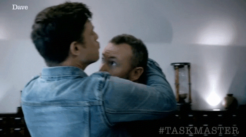 Two Men Are Hugging Each Other With The Word Dave On The Bottom Right GIF