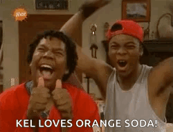 Two Men Are Laughing And Giving A Thumbs Up While Standing Next To Each Other In A Living Room . GIF
