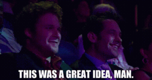 Two Men Are Laughing In A Crowd And One Of Them Is Saying This Was A Great Idea Man . GIF