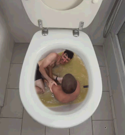 Two Men Are Laying In A Toilet With A Yellow Liquid GIF