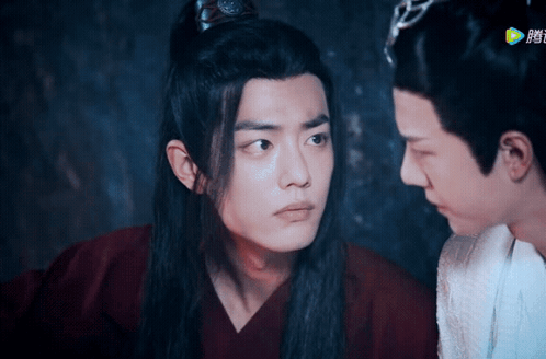 Two Men Are Looking At Each Other And One Is Wearing A Crown On His Head GIF