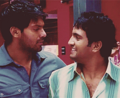 Two Men Are Looking At Each Other And One Of Them Is Wearing A Green Shirt GIF
