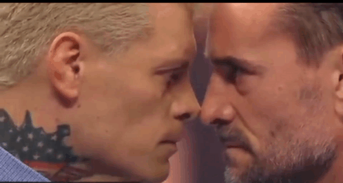 Two Men Are Looking At Each Other With Their Eyes Closed . GIF