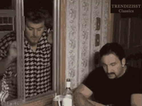 Two Men Are Looking Out Of A Window With The Words Trendizisst Classics On The Bottom Right GIF