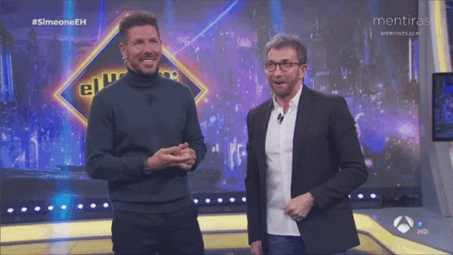 Two Men Are On A Stage With A Sign That Says Mentiras GIF