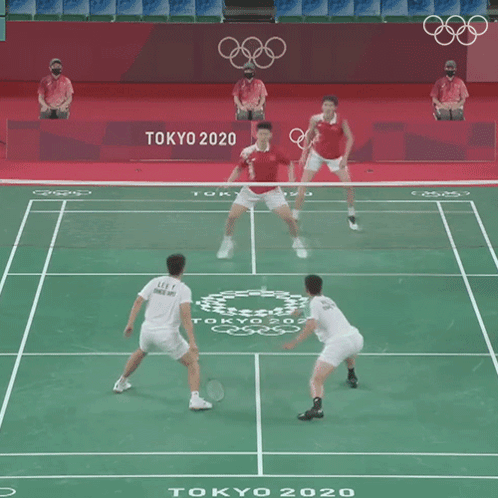 Two Men Are Playing A Game Of Badminton In Tokyo 2020 GIF