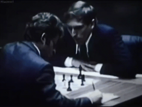 two men are playing a game of chess in a black and white photo with a caption that says " misconnected "