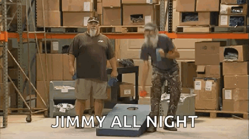 Two Men Are Playing A Game Of Cornhole In A Warehouse And The Words Jimmy All Night Are Written On The Screen . GIF