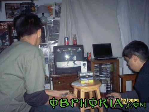 Two Men Are Playing A Video Game With The Date 12/2009 On The Bottom GIF