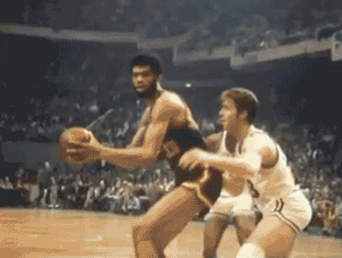 Two Men Are Playing Basketball In Front Of A Crowd And One Has The Number 3 On His Shorts GIF