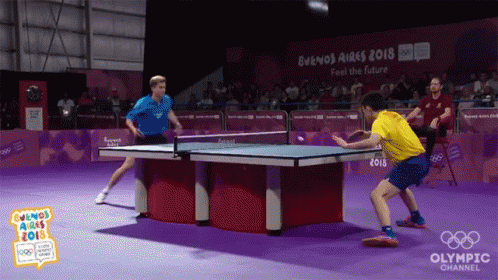 two men are playing ping pong at the buenos aires 2018 olympic channel event
