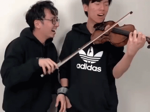 Two Men Are Playing Violins And One Has An Adidas Shirt On GIF